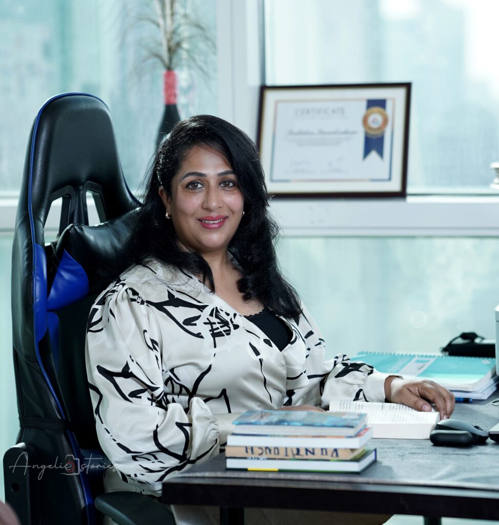 A confidently smiling expert portrait of a transformational coach, image consultant, NLP practitioner, counseling psychologist, and soft skills trainer.