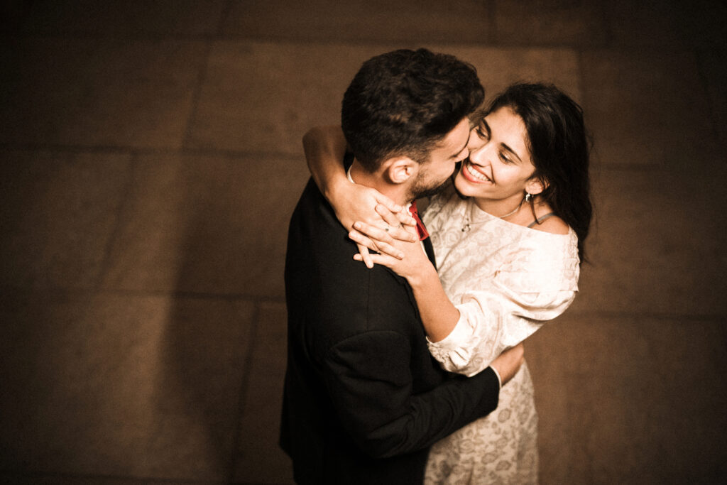 The impact of individualized mental wellness programs, emotional connection, and relationship harmony are symbolized by this happy couple grinning and embracing.